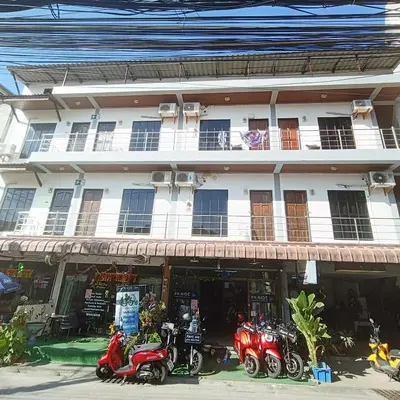 a group of motorcycles parked in front of a building at The Guest House - Apartment in Patong Beach