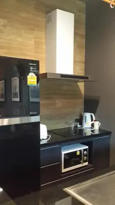 a kitchen with a sink and a microwave at Modern Luxury King Suite Pool View Sauna 57sqm in Rawai Beach