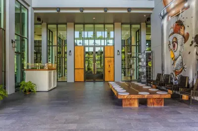 a lobby with a table in the middle of a building at Modern Luxury King Suite Pool View Sauna 57sqm in Rawai Beach