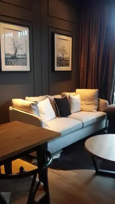 a living room with a couch and a table at Modern Luxury King Suite Pool View Sauna 57sqm in Rawai Beach