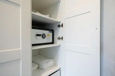 a closet with a microwave and towels at The Title Residencies Naiyang Pool View in Nai Yang Beach