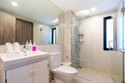 a bathroom with a toilet and a sink and a shower at The Beach Residence by EHM in Nai Yang Beach