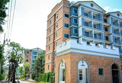 a tall brick building with a blue at The Beach Residence by EHM in Nai Yang Beach