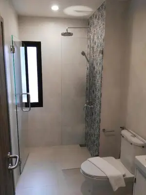 a bathroom with a shower and a toilet at The Beach Residence by EHM in Nai Yang Beach
