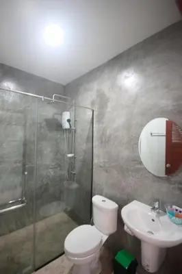 a bathroom with a shower and a toilet and a sink at The Aireen Hotel in Ao Nang Beach