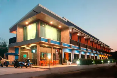 a building with two motorcycles parked in front of it at The Aireen Hotel in Ao Nang Beach