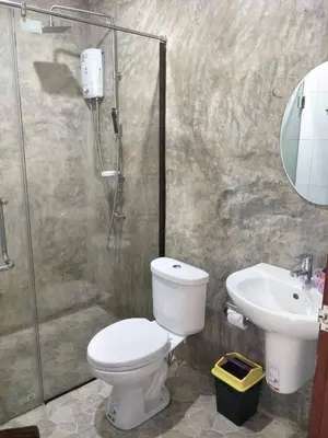 a bathroom with a shower and a toilet and a sink at The Aireen Hotel in Ao Nang Beach