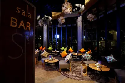 a restaurant with tables and chairs in a room at Mandarava Resort and Spa, Karon Beach in Karon Beach