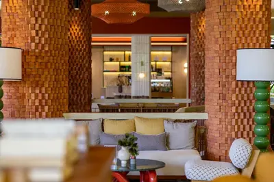 a lobby with a couch and chairs and a bar at Mandarava Resort and Spa, Karon Beach in Karon Beach
