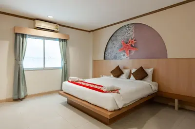 a bedroom with a bed with a starfish on the wall at The Eden Park in Patong Beach