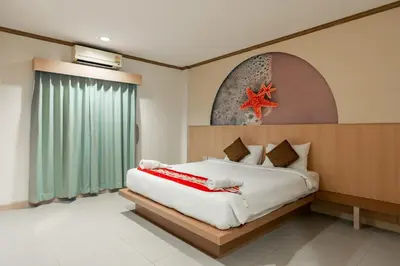 a bedroom with a bed with a starfish on the wall at The Eden Park in Patong Beach