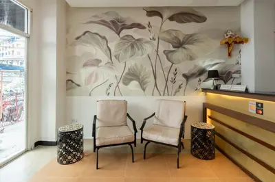 two chairs in front of a wall with a flower mural at The Eden Park in Patong Beach