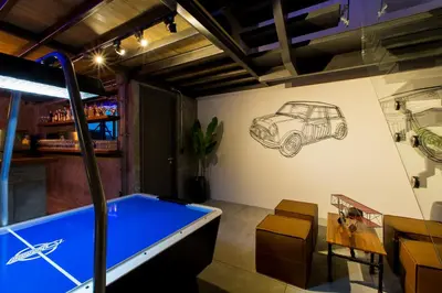 a room with a pool table and a drawing of a car on the wall at Villa Momo Private Pool near Kata Beach in Kata Beach