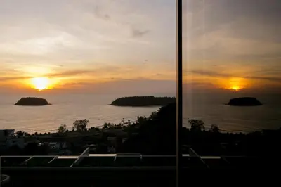 a view of the sunset from a building at The heights Penthouse Ocean view A11 Near Kata Beach in Kata Beach