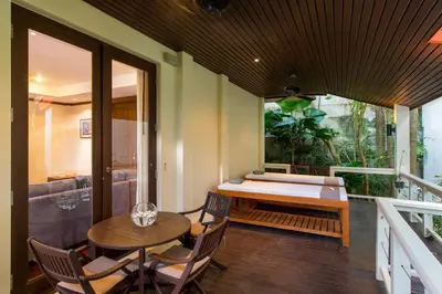 a balcony with a table and chairs and a bath tub at Katamanda Kata View villa E5 near kata Noi Beach in Kata Beach