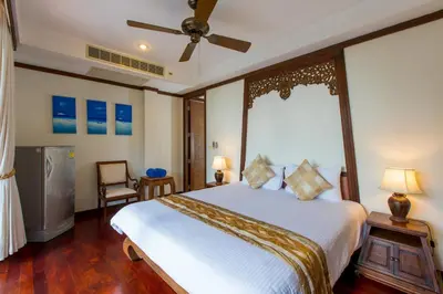 a bedroom with a large bed and a window at Katamanda Kata View villa E5 near kata Noi Beach in Kata Beach