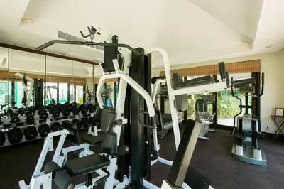 a gym with lots of treadmills and machines at Katamanda Kata View villa E5 near kata Noi Beach in Kata Beach