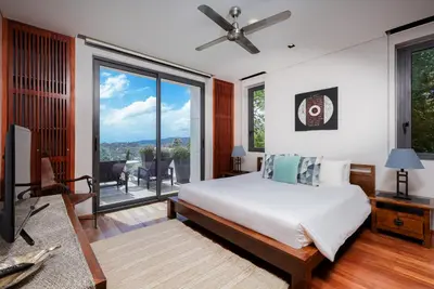 a bedroom with a bed and a large window at The heights Kata seaview C1 near Kata Beach in Kata Beach