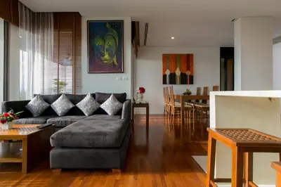 a living room with a couch and a dining room at Kata Gardens Penthouse sea view 4C near Kata Noi Beach in Kata Beach