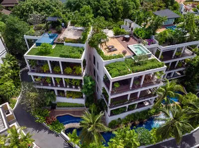 an apartment building with plants on its roof at Kata Gardens Penthouse sea view 4C near Kata Noi Beach in Kata Beach
