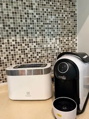 a toaster and a slow cooker sitting on a counter at Kata Gardens Luxury Apartment 8B at Kata Noi Beach in Kata Beach