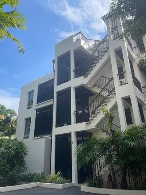 a white building with stairs on the side of it at Kata Gardens Luxury Apartment 8B at Kata Noi Beach in Kata Beach