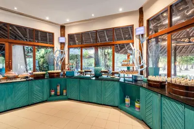 a restaurant with green counters and windows at SAii Phi Phi Island Village in Phi Phi Don