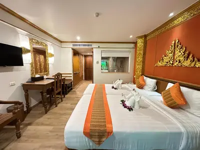 a hotel room with a large bed and a piano at Kata Palm Resort - SHA Plus in Kata Beach