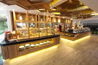a store with two counters with food on display at Kata Palm Resort - SHA Plus in Kata Beach