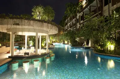 a swimming pool in a hotel at night at Kata Palm Resort - SHA Plus in Kata Beach