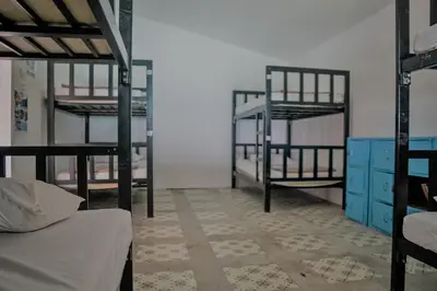 a room with two bunk beds and a room with a room with at Blanco Beach Bar Hostel in Phi Phi Don