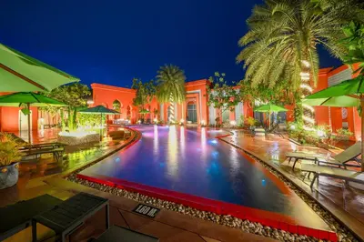 a swimming pool at a resort at night at The Kiri Villas Resort in Thalang
