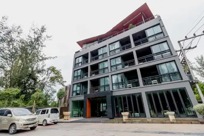 a building with cars parked in front of it at Studio at Kris Condo walk to Bangtao beach 2304 in Bang Tao Beach