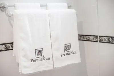 a group of towels on a towel rack in a bathroom at Peranakan Boutique Hotel - SHA Plus in Phuket Town