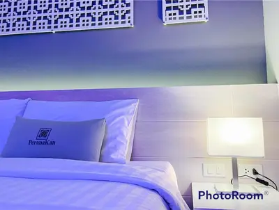 a bedroom with a white bed and a lamp at Peranakan Boutique Hotel - SHA Plus in Phuket Town