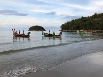 three boats in the water on a beach at Twin Villas Seaview Kata in Kata Beach