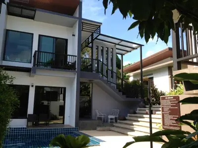 a house with a staircase in front of it at Alphabeto Resort in Nai Harn Beach