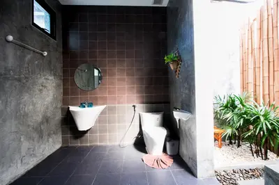a bathroom with a toilet and a sink at Alphabeto Resort in Nai Harn Beach