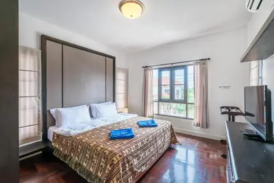 a bedroom with a bed with two blue boxes on it at Sea eagle pool villa in Ao Nang Beach