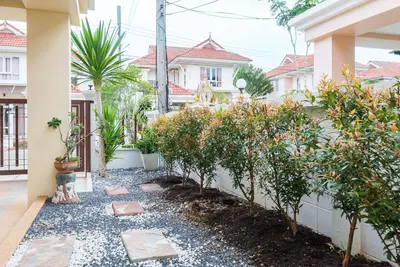 a garden in front of a house with trees at Sea eagle pool villa in Ao Nang Beach