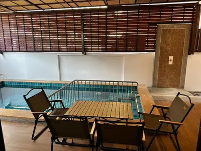 a table and chairs next to a swimming pool at Poonsiri Private Pool Villa Aonang in Ao Nang Beach