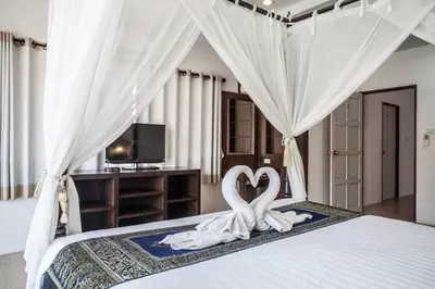 a bedroom with two swans in the middle of a bed at Poonsiri Private Pool Villa Aonang in Ao Nang Beach