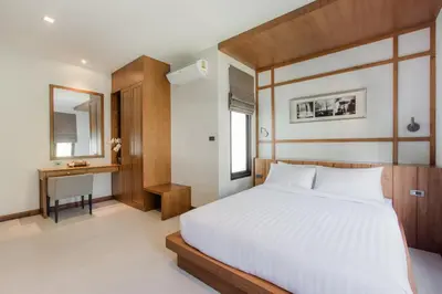 a bedroom with a large white bed and a desk at Villa Palavee (B2) in Ao Nang Beach