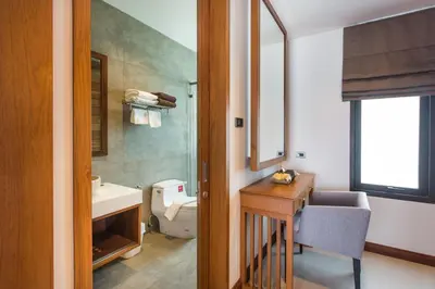 a bathroom with a sink and a toilet and a mirror at Villa Palavee (B2) in Ao Nang Beach