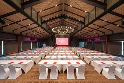 a large banquet hall with white tables and chairs at Ramada Plaza by Wyndham Chao Fah Phuket in Phuket Town