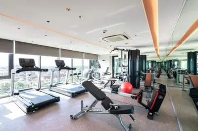 a gym with treadmills and exercise equipment in a building at Ramada Plaza by Wyndham Chao Fah Phuket in Phuket Town