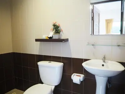 a bathroom with a toilet and a sink at Canal Resort in Nai Yang Beach