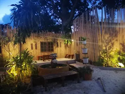 a backyard with a fence and a bench and a tree at Phi Phi Long Beach Bungalow ( Had Yao) in Phi Phi Don