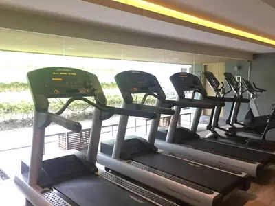 a row of treadmills in a gym at Baan Mai Khao condo in Mai Khao Beach