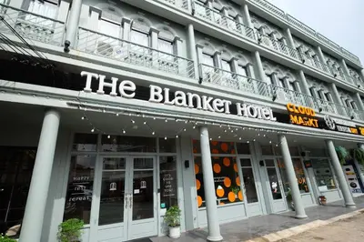 a building with a sign that reads the banquet house at The Blanket Hotel Phuket Old Town in Phuket Town